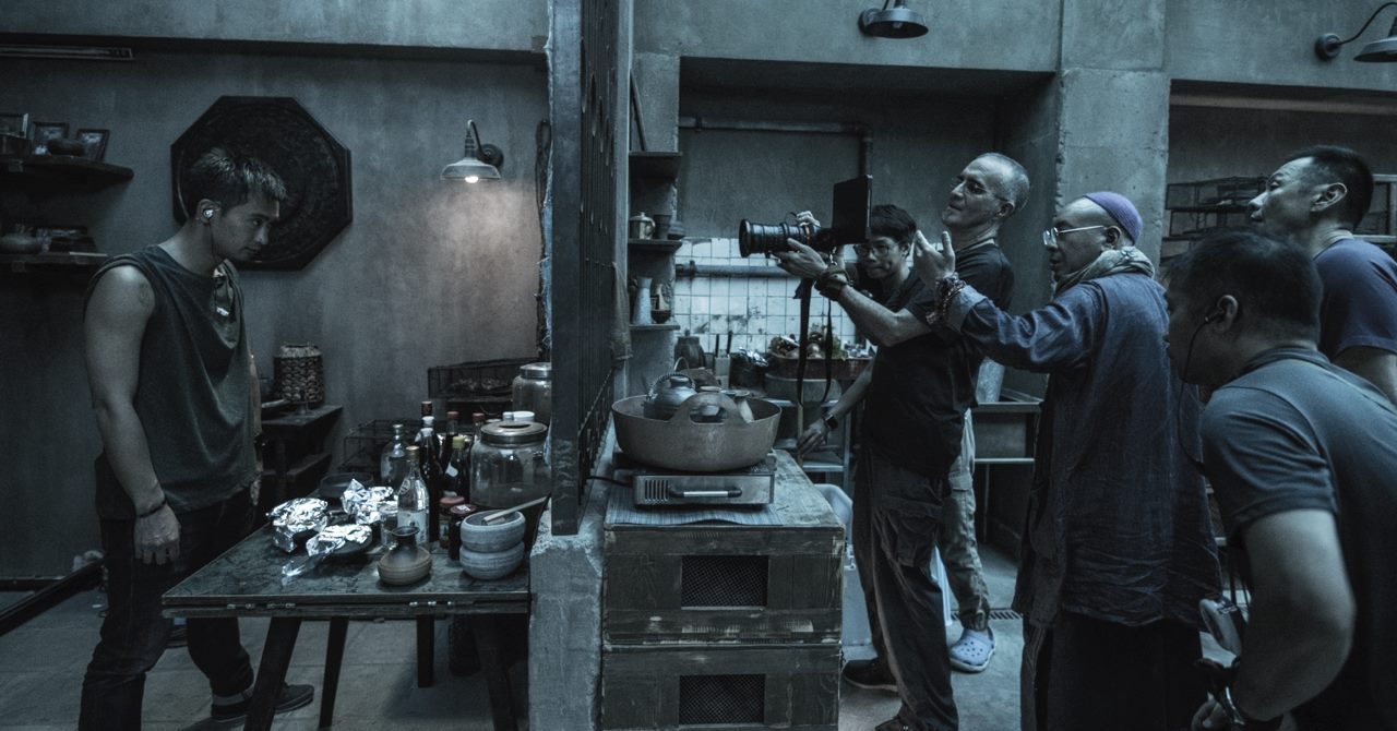 A cinematographer framing through Artemis Prime on a period drama set